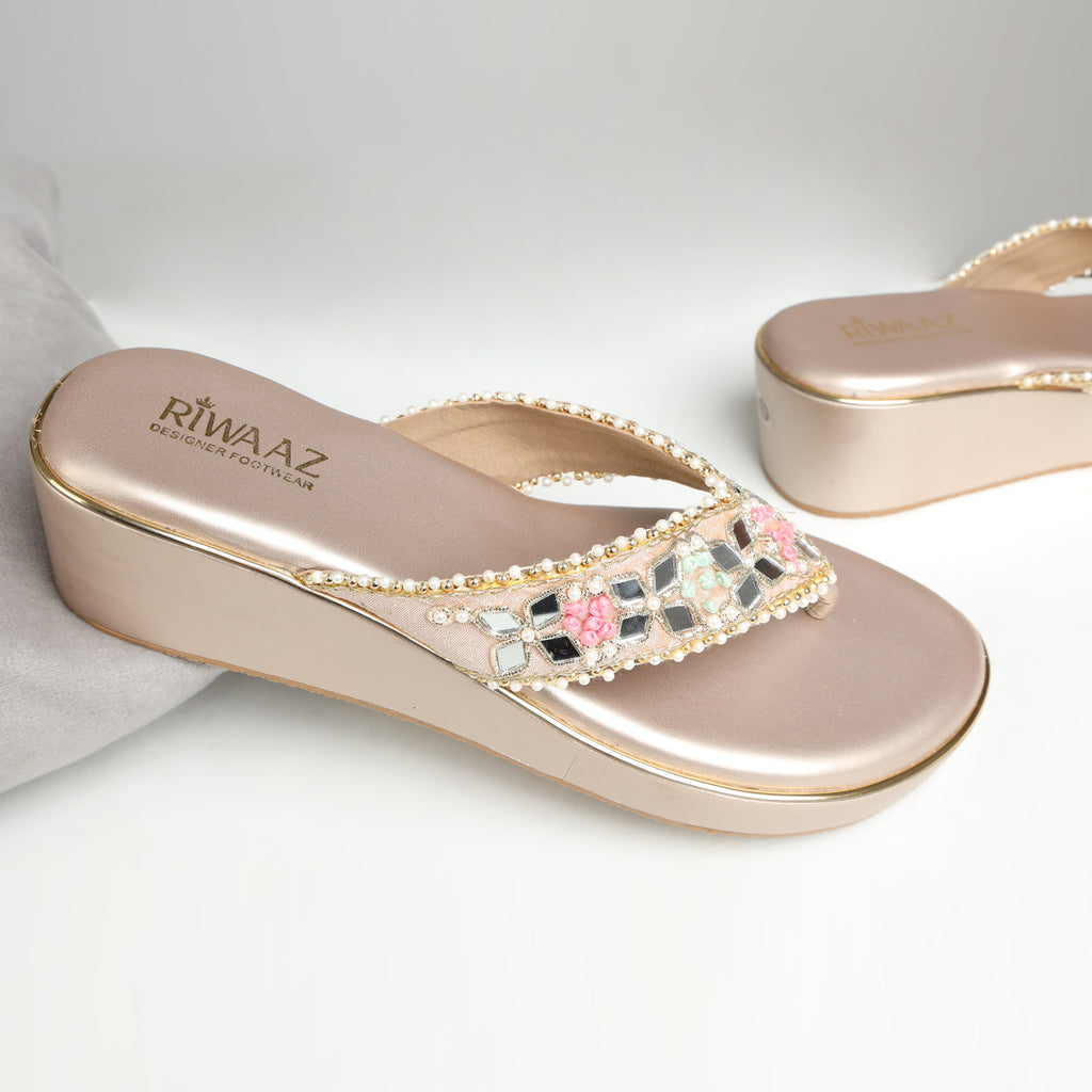 Close-up of Riwaaz Pastel Bloom wedge platforms worn with pink ethnic wear, showing mirror and pearl embellished strap