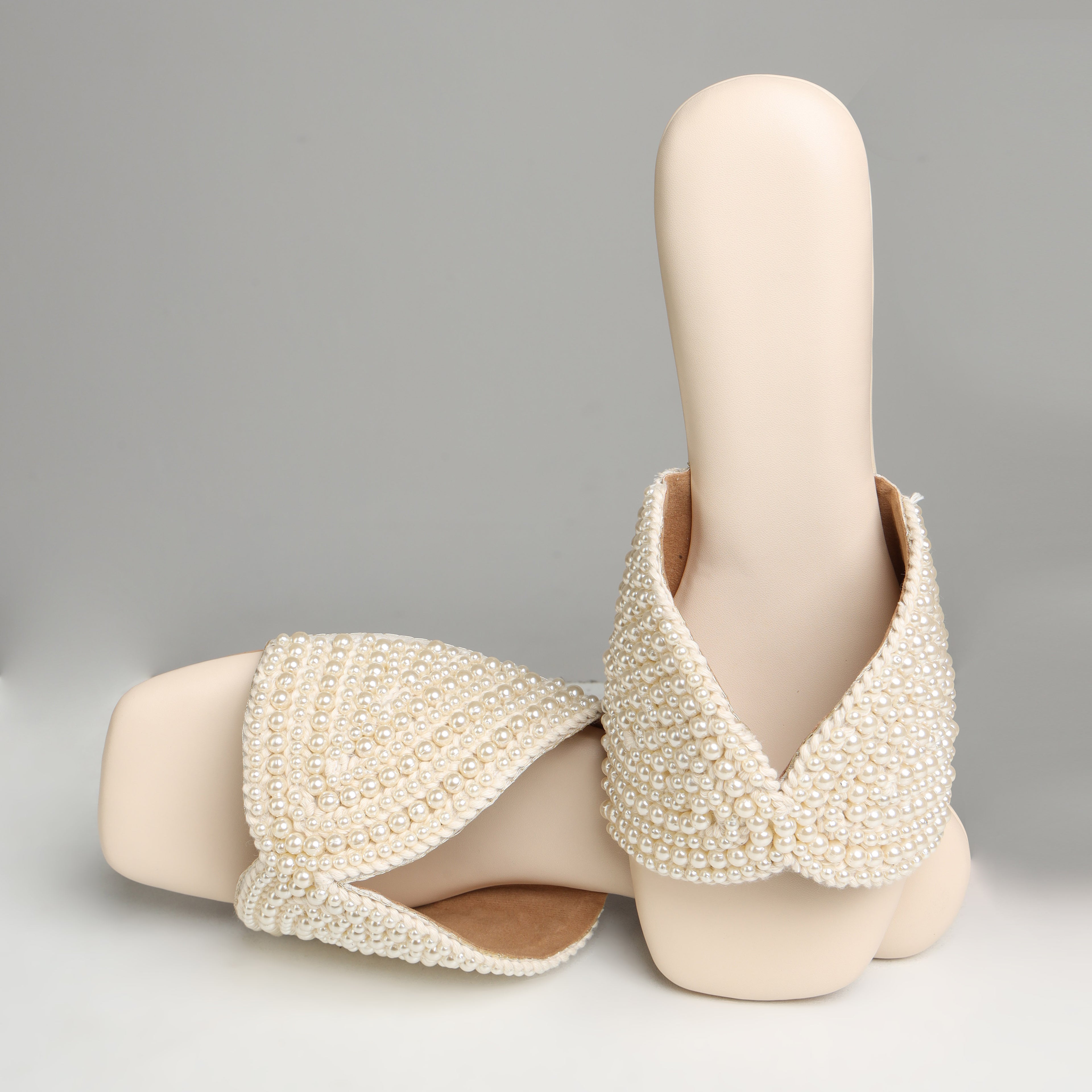 Riwaaz Noor-e-Moti white pearl flat slides – angled product shot showing pearl embellishment detail and cushioned footbed