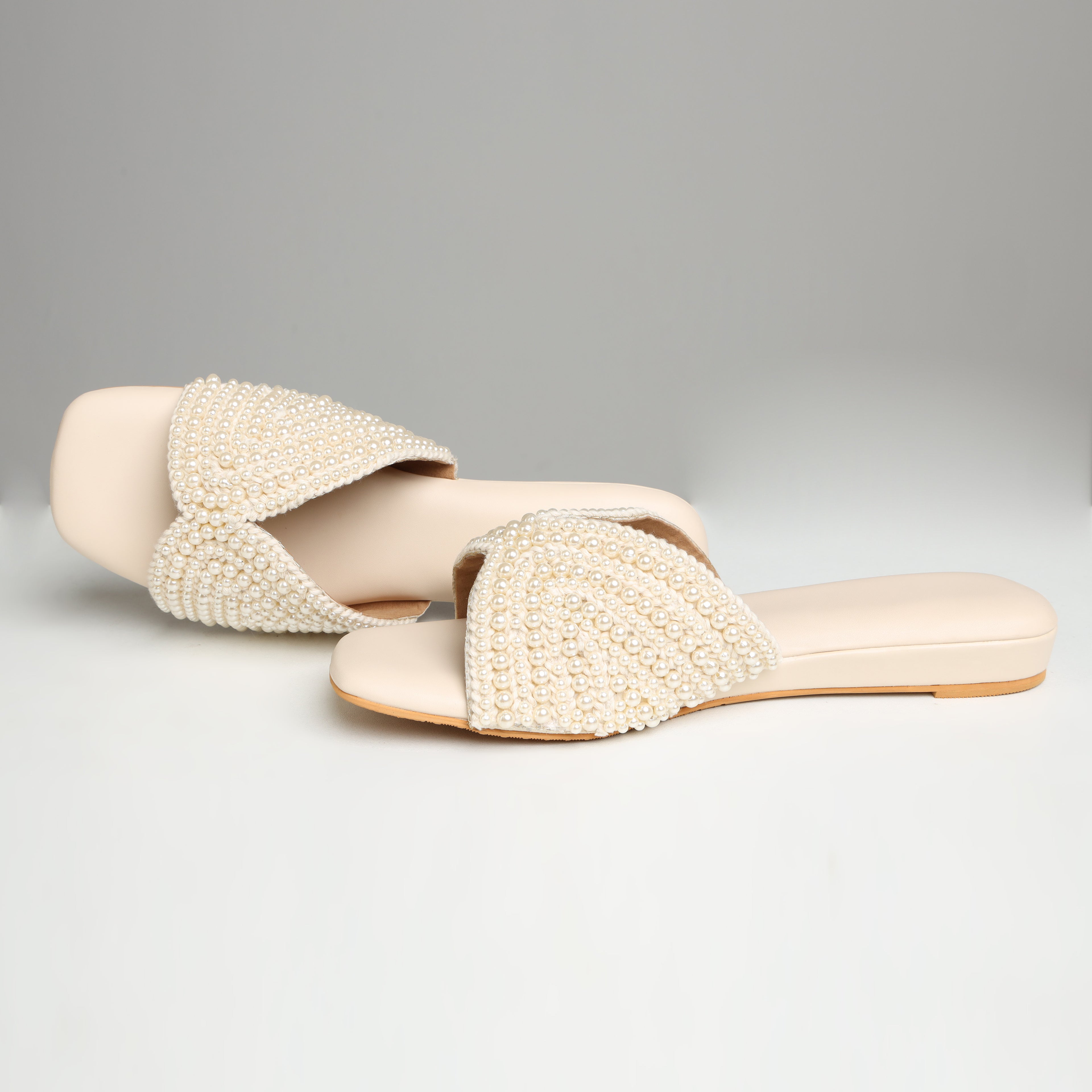 Top view of Riwaaz Noor-e-Moti all-over pearl embellished flat slides showing crossover strap design and square toe