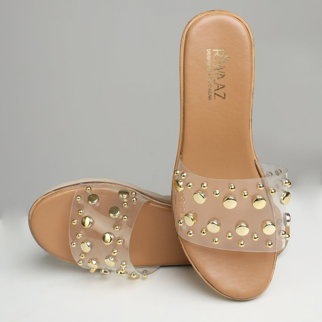 Single Riwaaz Nora gold studded clear silicone strap wedge slide – side profile showing platform height and wood-effect sole