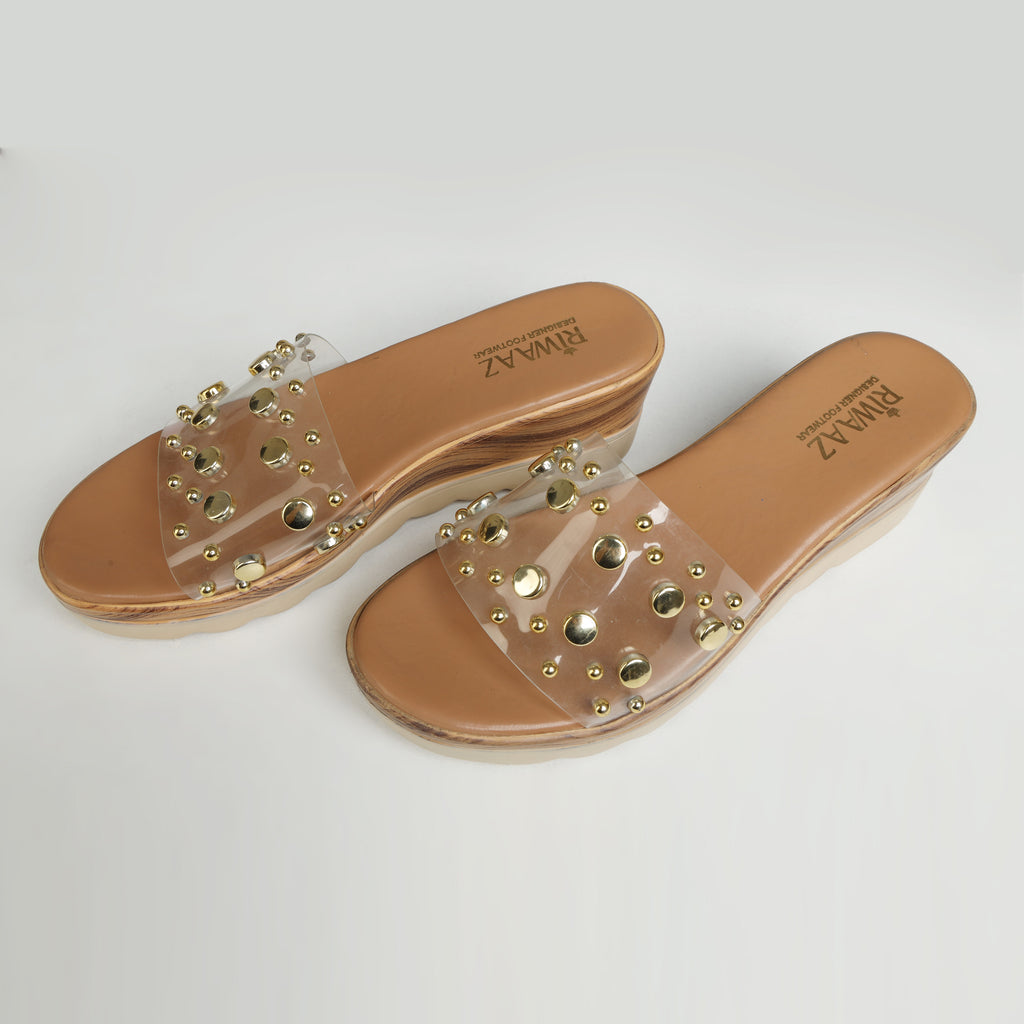 Dark beige Riwaaz Nora gold studded clear silicone strap wedge slide on wood-effect platform sole – product shot on grey background