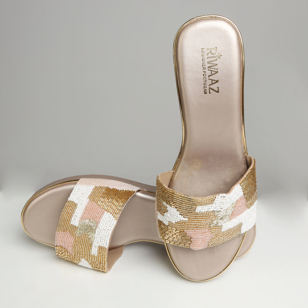 Pair of Riwaaz Gulnaar dull gold bead embroidered wedge slides – angled top view showing full bead embroidery detail and gold trim