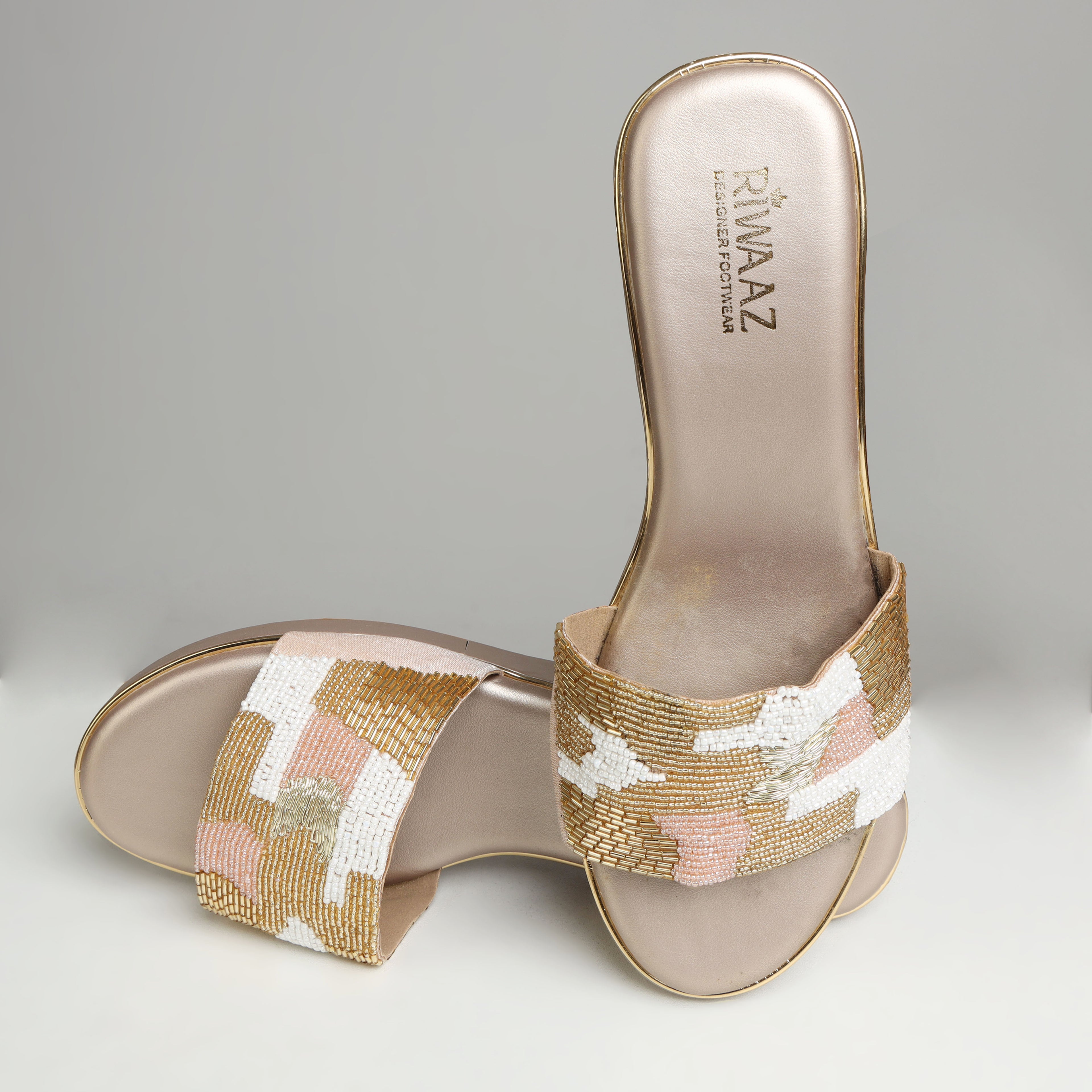 Pair of Riwaaz Gulnaar dull gold bead embroidered wedge slides – angled top view showing full bead embroidery detail and gold trim