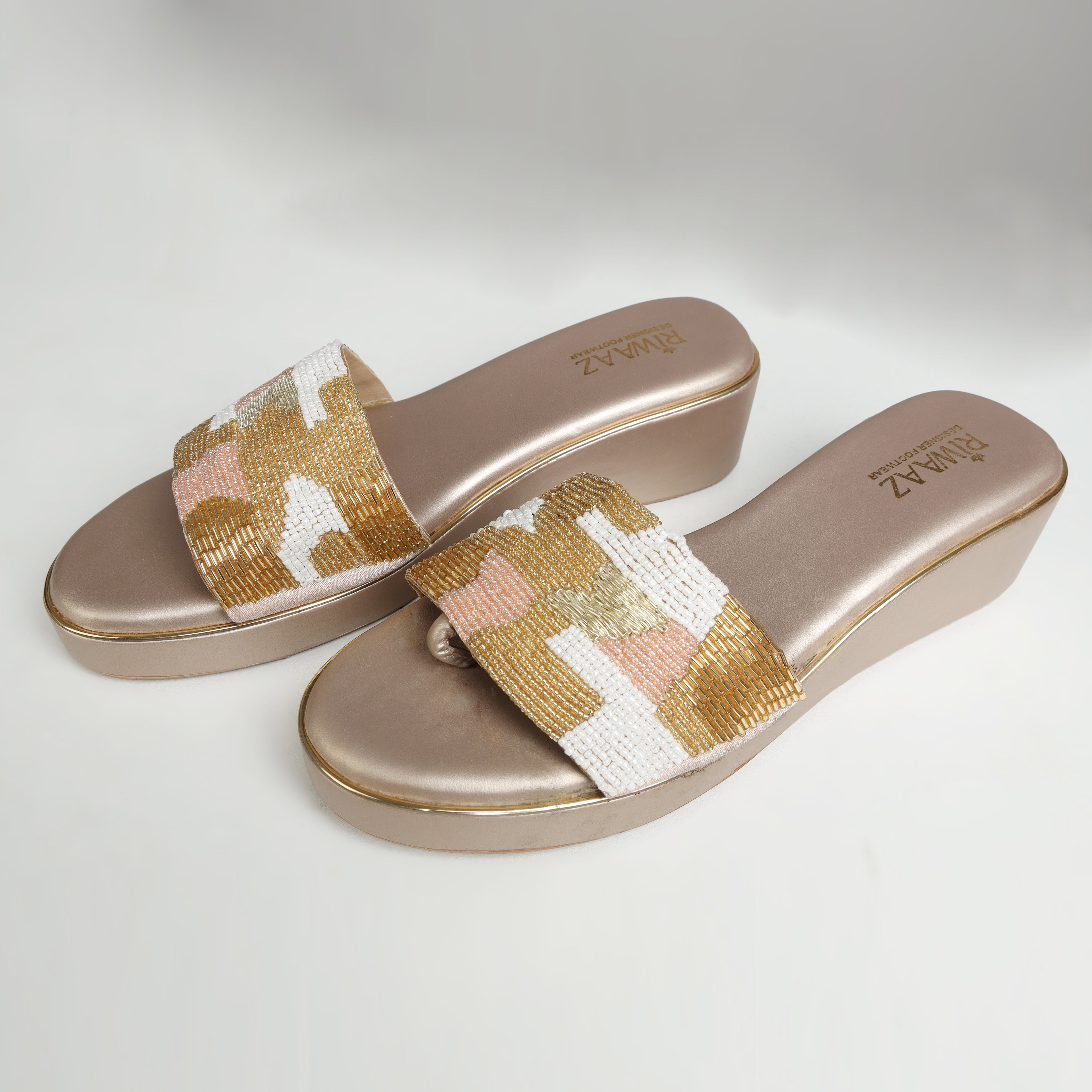Riwaaz Gulnaar ivory gold blush bead embroidered wedge slides – pair laid flat showing rubber sole and Riwaaz branded insole