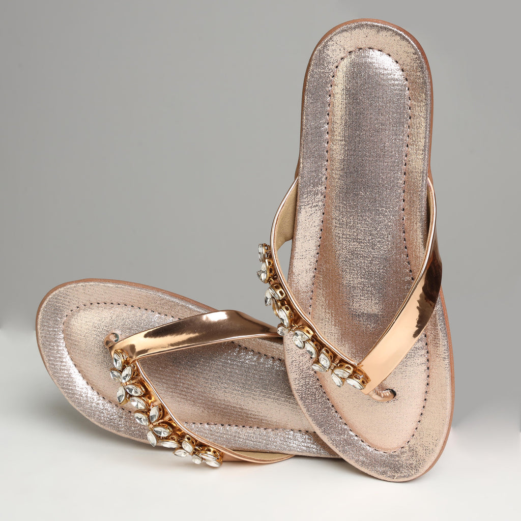 Riwaaz Ziva rose gold Kundan flip flops – pair laid flat on grey background showing rubber sole and shimmer insole