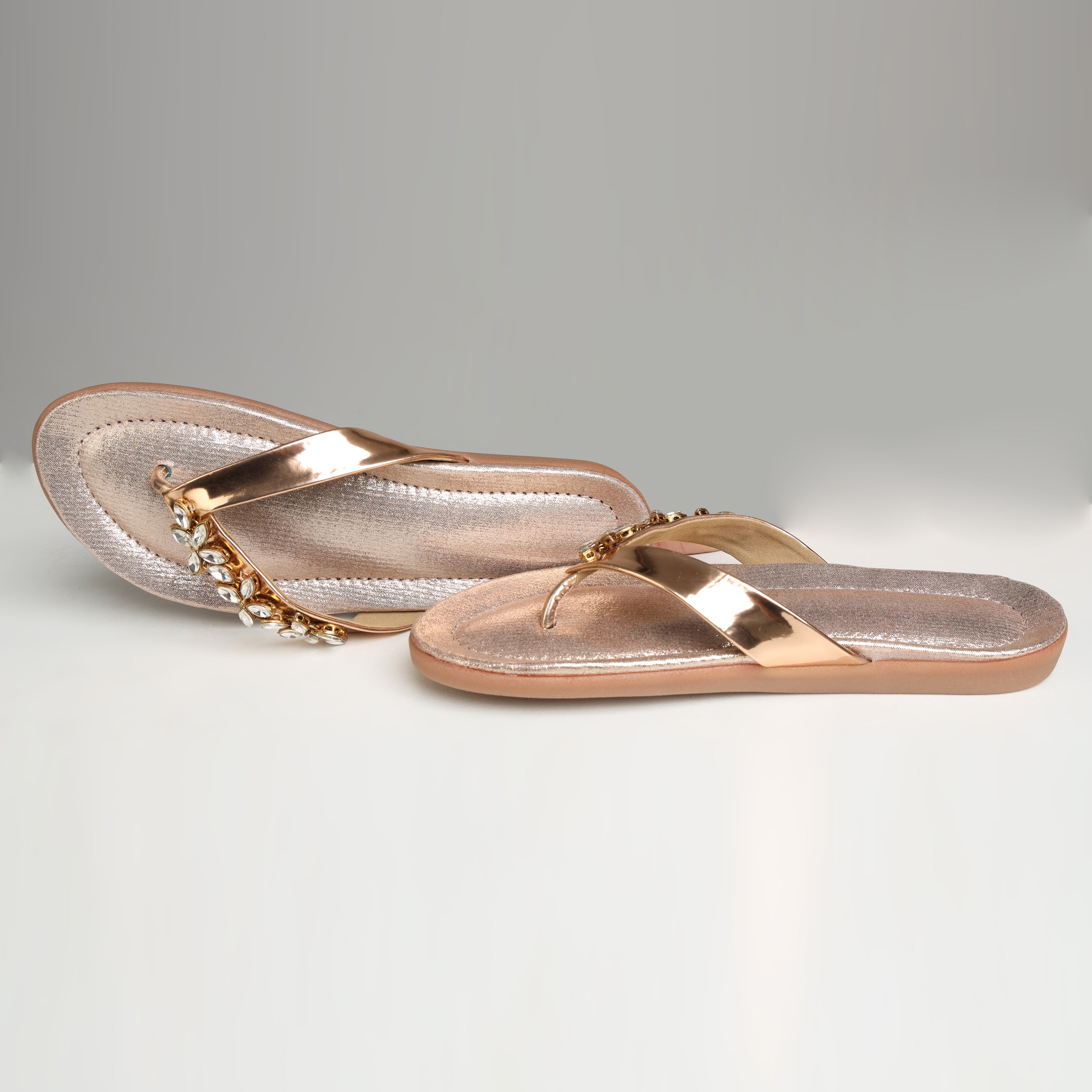 Single Riwaaz Ziva dull rose gold Kundan flip flop – angled product shot showing Kundan crystal embellishment and shimmer footbed