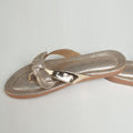 Dull rose gold Riwaaz Misha mirror work and pastel French knot flip flops – product shot on marble surface with gold tray, white vase and cream rose