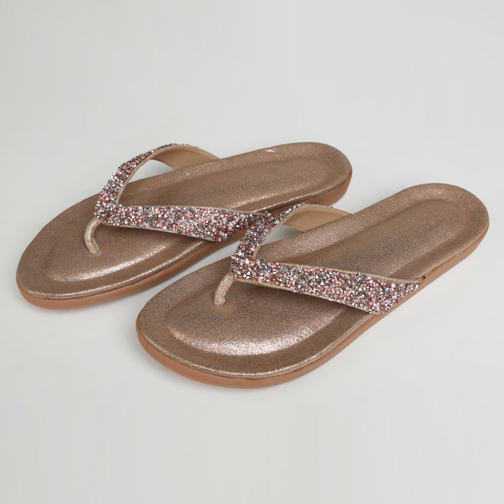 Single Riwaaz Aurelia dull rose gold crystal flip flop – close-up angled shot on white background showing dense crystal embellishment on V-strap