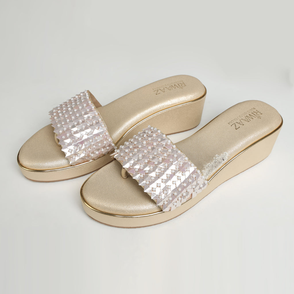 Single Riwaaz Chandni Glow dull gold wedge sandal – side profile on white background showing 2-inch wedge sole, gold trim, and pearl sequin strap