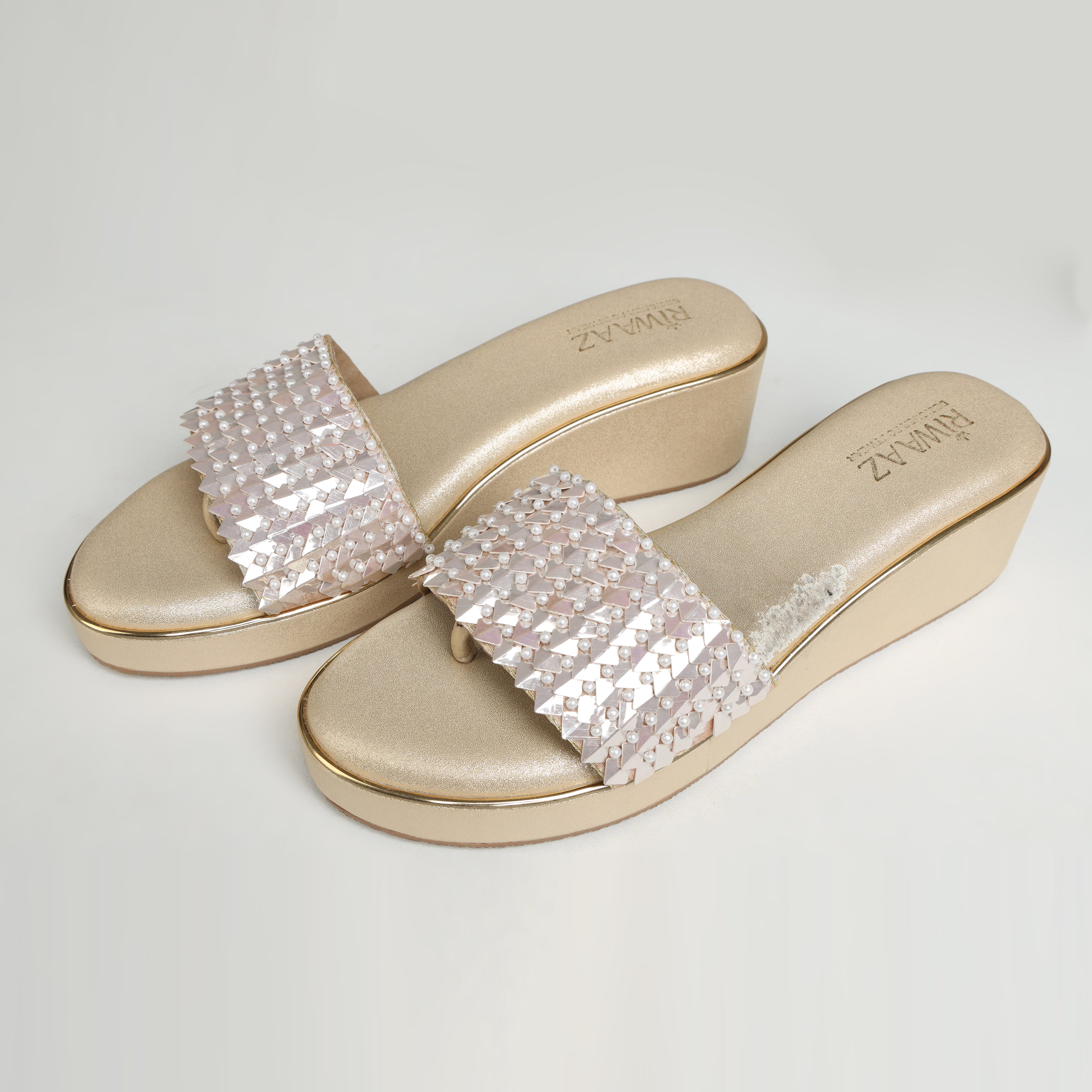 Single Riwaaz Chandni Glow dull gold wedge sandal – side profile on white background showing 2-inch wedge sole, gold trim, and pearl sequin strap