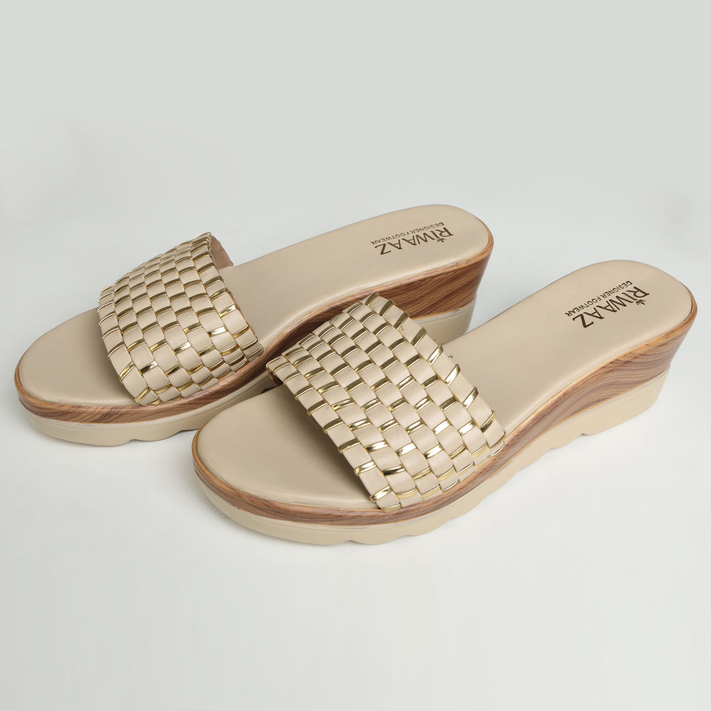 Single Riwaaz Ava cream woven metallic slide – side profile on white background showing wood-effect wedge sole, cream outsole, and woven strap detail
