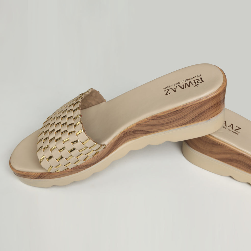 Pair of Riwaaz Ava cream woven platform slides – angled product shot on white background showing cushioned footbed and full woven strap with metallic gold thread