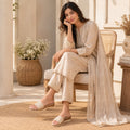 Pair of Riwaaz Ava cream woven platform slides on white background – side angle showing wood-effect wedge sole profile and cream rubber outsole