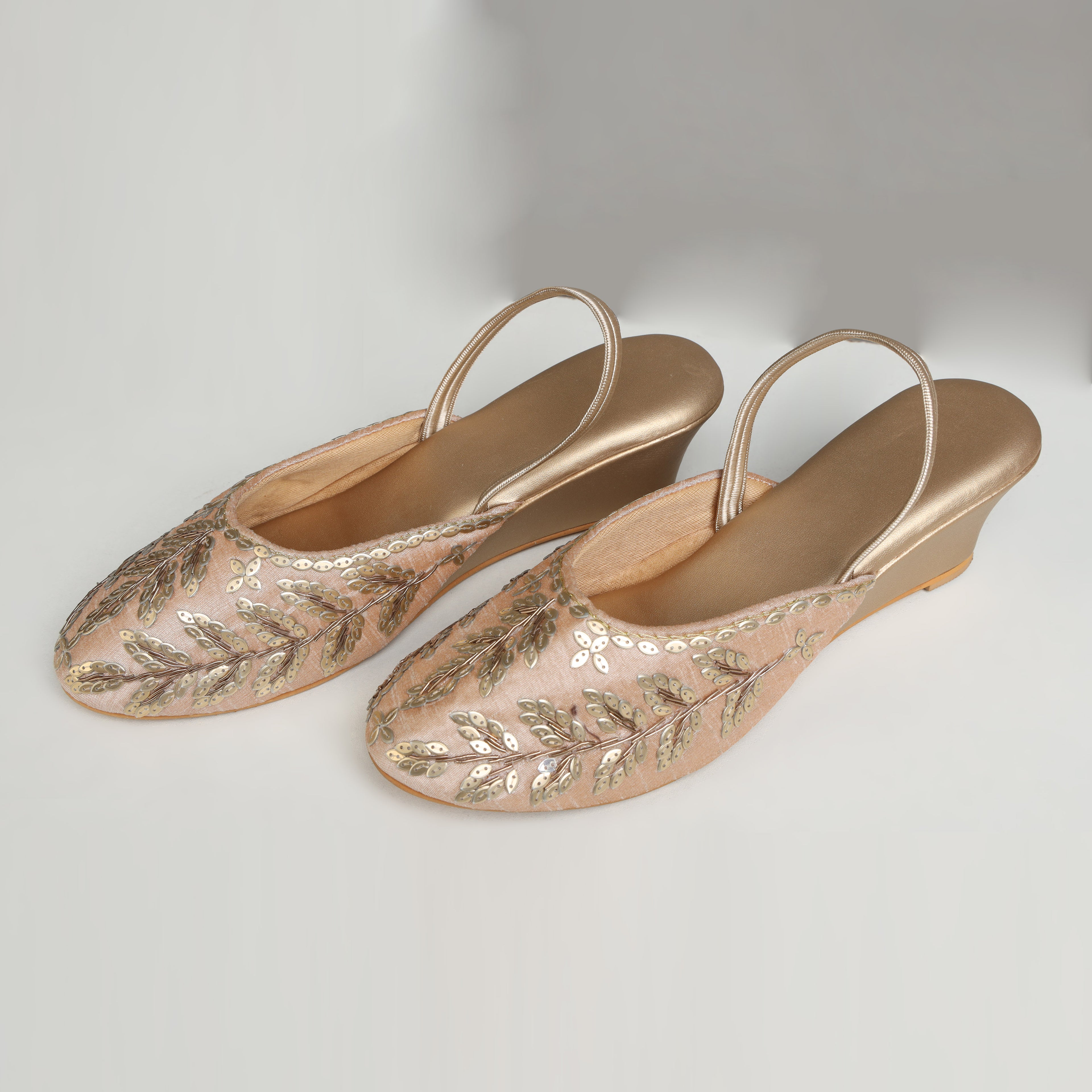 Single Riwaaz Zehra dull gold sequin leaf embroidered slingback wedge mule – side profile product shot on white background with gold wedge heel and double satin back strap detail