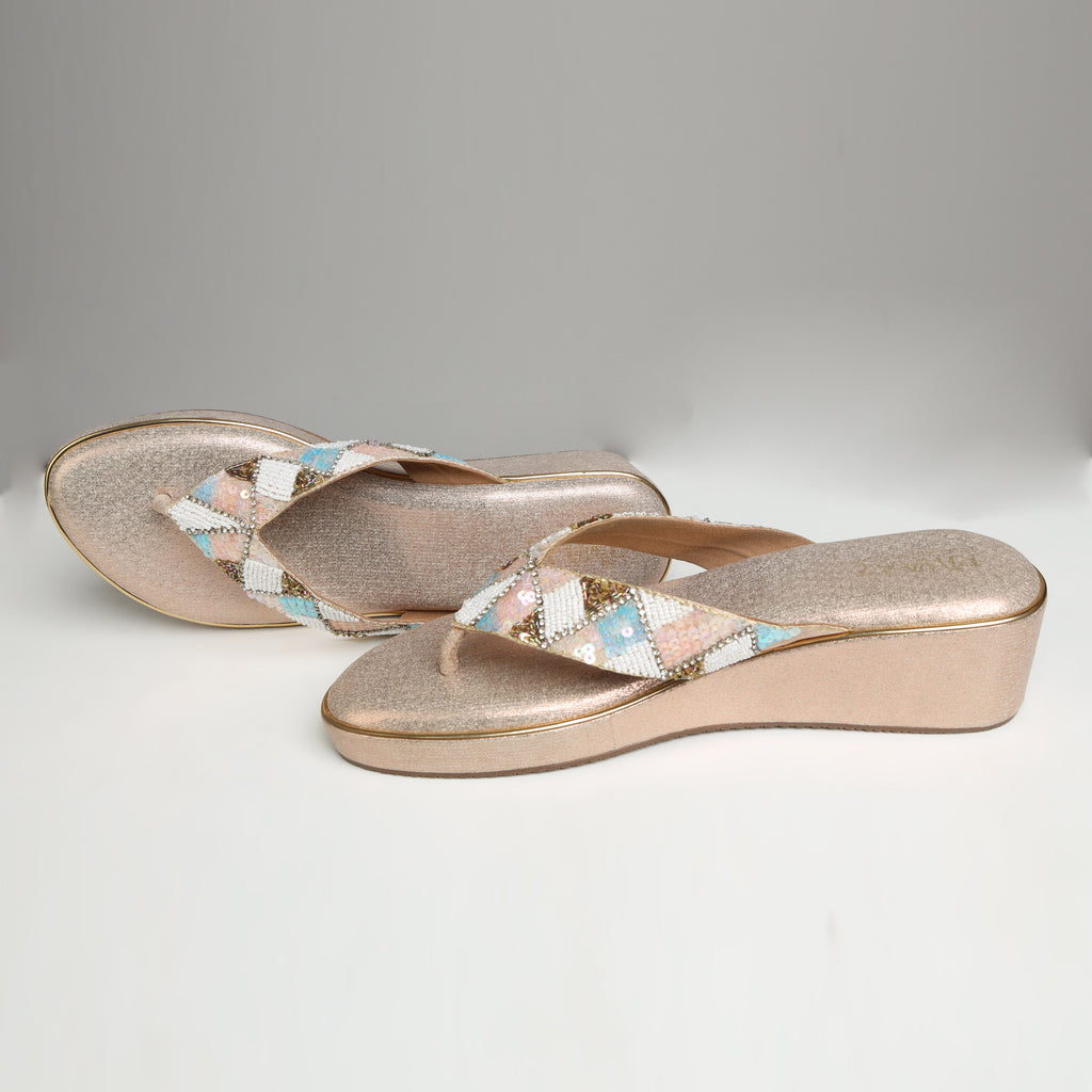 Pair of Riwaaz Afreen dull rose gold pastel geometric beaded thong wedge platforms on white background – angled top view showing shimmer rose gold insole and full geometric beaded thong strap with mint, blush and white diamonds