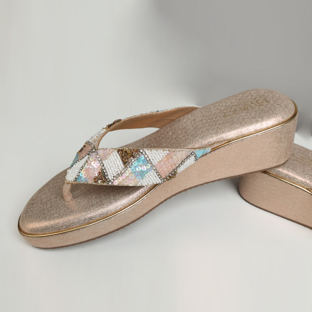 Pair of Riwaaz Afreen dull rose gold pastel geometric beaded thong wedge platforms – top-down product shot on white background showing rose gold shimmer insole and full pastel geometric beaded thong strap
