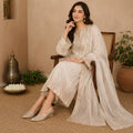 Pair of Riwaaz Zehra dull gold sequin leaf embroidered slingback wedge mules on white background – three-quarter view showing double satin back strap, gold wedge heel and embroidered toe box